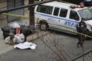 Police guard a sheet-covered plastic bag, left, on Eagle Avenue in the Bronx borough of New York, Tuesday, Feb. 26, 2013. A man out walking his dog early Tuesday morning discovered the dismembered remains of a woman in heavy duty plastic garbage bags, police said. The body is believed to be that of a 45-year-old woman. Her name was not immediately released, and the medical examiner's office was working to determine a cause of death. (AP Photo/Bebeto Matthews)