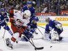 Maple Leafs goalie Reimer looks on with teammate Kadri against Hurricanes Ruutu during their NHL hockey game in Toronto