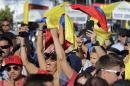 Fans celebrate with Colombian flags after Juan Pablo Montoya, of Colombia, won the IndyCar Firestone Grand Prix of St. Petersburg auto race Sunday, March 29, 2015, in St. Petersburg, Fla. (AP Photo/Chris O'Meara)
