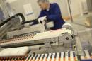 A Novo Nordisk employee controls a machine at an insulin production line in a plant in Kalundborg