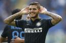 Inter Milan forward Mauro Icardi, of Argentina, celebrates after scoring during a Serie A soccer match between Inter Milan and Sassuolo, at the San Siro stadium in Milan, Italy, Sunday, Sept.14, 2014. (AP Photo/Luca Bruno)