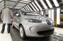 An employee inspects a Renault Zoe electric car at the Renault automobile factory in Flins