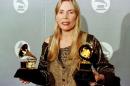 US singer Joni Mitchell is seen holding two Grammy Awards during the 38th Annual Grammy Awards in Los Angeles, on February 28, 1996