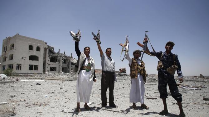 Shiite fighters, known as Houthis, hold up their weapons as they chant slogans at the residence of a military commander of the Houthi militant group, destroyed by a Saudi-led airstrike in Sanaa,, Yemen, Tuesday, April 28, 2015. A security official in Saudi Arabia says a soldier has been killed and another wounded in a gunfight with Shiite Houthi rebels along the kingdom&#39;s southern border with Yemen. (AP Photo/Hani Mohammed)