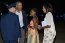 President Barack Obama, second from left, Sasha Obama, and first lady Michelle Obama, are greeted as they exit Air Force One on arrival at Andrews Air Force Base, Md., on Sunday Aug. 18, 2013, after a family vacation on the island of Martha's Vineyard. Also with them was Malia Obama, not pictured. (AP Photo/Jacquelyn Martin)