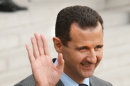 FILE - In this Friday Nov. 13, 2009 file photo, Syrian President Bashar Assad waves a goodbye as he leaves the Elysee Palace following his meeting with his French counterpart Nicolas Sarkozy, in Paris. Arab identity is back on the right track after the fall from power of Egypt's Muslim Brotherhood, which had used religion for its own political gain, Assad said in remarks published Thursday. (AP Photo/Remy de la Mauviniere, File)