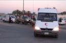This image made from AP video shot on Wednesday, June 4, 2014 shows an ambulance carrying the body of a staff member of the International Committee of the Red Cross (ICRC), who was killed by armed men near the city of Sirte, which is around 550 kilometers (340 miles) east of Tripoli, Libya. ICRC Director-General Yves Daccord said in a statement on the organization's website Thursday, June 5, 2014 that Michael Greub, a 42-year-old Swiss national, was killed when the men attacked his car after he left a meeting.(AP Photo via AP video)