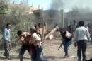 An image grab taken from a video uploaded on YouTube on October 16, 2012, allegedly shows Syrians carrying wounded civilians following the shelling of homes by government forces in the village of Mayadeen