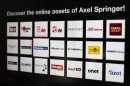 Logos of the digital products of the Axel Springer media group are presented before a news conference on annual results in Berlin