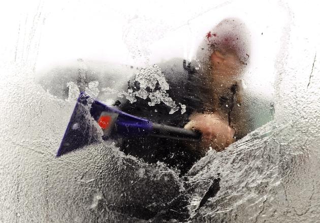 Tyla Crocker uses her lunch break from her job at J.C. Penney's at the Bangor Mall to scrape the ice from her car windows in Bangor