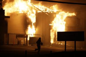 A man runs away from the burning storage facility after&nbsp;&hellip;