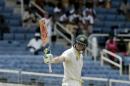Australia batsman Steven Smith raises his bat after reaching 150 runs during day two of their second cricket Test match against West Indies in Kingston, Jamaica, Friday, June 12, 2015. (AP Photo/Arnulfo Franco)