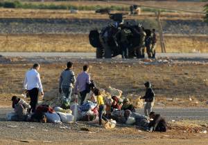 Syrian refugees from Kobani rest after arriving at &hellip;