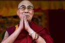 The Dalai Lama visited the Glastonbury music festival for the first time, addressing revellers on how the world could be a better place