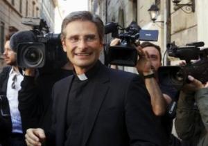 Monsignor Krzystof Charamsa smiles as he leaves at the end of his news conference in downtown Rome