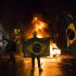 A demonstrator holds a Brazilian flag in front of a burning barricade during a protest in Rio de Janeiro in Rio de Janeiro, Brazil, Monday, June 17, 2013. Protesters massed in at least seven Brazilian cities Monday for another round of demonstrations voicing disgruntlement about life in the country, raising questions about security during big events like the current Confederations Cup and a papal visit next month. (AP Photo/Felipe Dana)