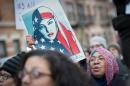 A woman holds a sign as the Astoria community stands together with Muslim-Americans and Muslim immigrants during a rally, February 3, 2017 in New York