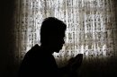 Naser Gulzad, 25, prays in his Kabul home