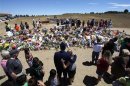 People surround a memorial to remember those killed in Aurora, Colorado