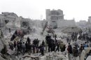 Excavator is used to search for survivors after a Syrian army rocket attack on the rebel-held Jabal Badro district in the city of Aleppo