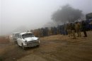 Vehicles carrying mourners and officials leave a cremation ground after attending the funeral of a rape victim in New Delhi