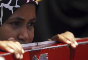 A female member of the Muslim Brotherhood and supporter of ousted Egyptian President Mohamed Mursi looks at Rabaa Adawiya Square, where they are camping, in Nasr city area, east of Cairo