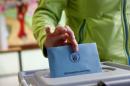 A woman casts her vote during regional elections at a polling station in Bad Kreuznach