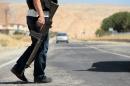 A member of the Turkish security forces stands guard at a check point on the main road to southeastern town of Silvan