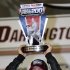 Kyle Busch holds the trophy in Victory Lane after winning the NASCAR Nationwide series auto race at Darlington Raceway, Friday, May 10, 2013, in Darlington, S.C.  (AP Photo/Mic Smith)