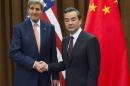 Chinese Foreign Minister Wang Yi and U.S. Secretary of State John Kerry shake hands prior to meetings at the Ministry of Foreign Affairs in Beijing