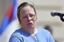 Rowan County, Ky. Clerk Kim Davis shows emotion as she is cheered by a gathering of supporters during a rally on the steps of the Kentucky State Capitol in Frankfort Ky. The U.S. Supreme Court on Monday, Aug. 31, 2015, ruled against Davis, who has refused to issue same-sex marriage licenses. (AP Photo/Timothy D. Easley, File)