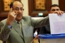 Iraqi Prime Minister Nuri al-Maliki shows his ink-stained finger as he casts his vote in Iraq's first parliamentary election since US troops withdrew at a polling station in Baghdad's fortified Green Zone, on April 30, 2014