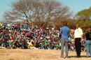 AMCU leader Joseph Mathunjwa (C) addresses mineworkers gathered in the Marikana area, near Rustenburg, on August 20, 2013