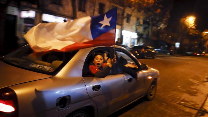 Chilean fans wave a national flag from a car as they celebrate Chile&#39;s victory over Peru in their Copa America 2015 semi-final soccer match in Concepcion