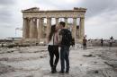 U.S. visitors Zach Branch,19, right, and Madison Franklin, 18, both from California, kiss in front of the Parthenon during their visit at the Acropolis hill in Athens, on Wednesday, April 15, 2015. The strong U.S. dollar makes European vacations cheaper for American tourists. U.S. bookings to some European countries are up 20 percent so far, according to European tourism officials and American travel companies. (AP Photo/Yorgos Karahalis)