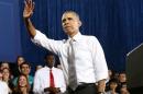 U.S. President Barack Obama waves during a visit to Coral Reef High School in Miami