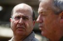 Israeli Defense Minister Yaalon looks at Israel's armed forces chief Major-General Gantz during a visit to a military base outside central Gaza Strip