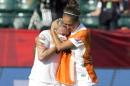 England's Josanne Potter, right, consoles Laura Bassett (6) after a 2-1 loss to Japan in a semifinal in the FIFA Women's World Cup soccer tournament, Wednesday, July 1, 2015, in Edmonton, Alberta, Canada. (Jason Franson/The Canadian Press via AP)