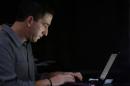 Glenn Greenwald, the blogger and journalist who broke the U.S. NSA surveillance scandal, uses his laptop after an exclusive interview with Reuters in Rio de Janeiro