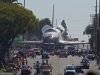 The space shuttle Endeavour is slowly moved down Crenshaw Blvd., Saturday, Oct. 13, 2012, in Los Angeles. The shuttle is on its last mission — a 12-mile creep through city streets. It will move past an eclectic mix of strip malls, mom-and-pop shops, tidy lawns and faded apartment buildings. Its final destination: California Science Center in South Los Angeles where it will be put on display. (AP Photo/Mark J. Terrill)