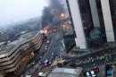 LONDON, UNITED KINGDOM - JANUARY 16: (BEST QUALITY AVAILABLE) Smoke pours from the burning debris of a helicopter which crashed in the Vauxhall area, January 16, 2012 in London, England. The helicopter appeared to hit a crane attached to the nearby St Georges Wharf Tower before plunging into the road below during the morning rush hour. (Photo by Victor Jimenez/Getty Images)