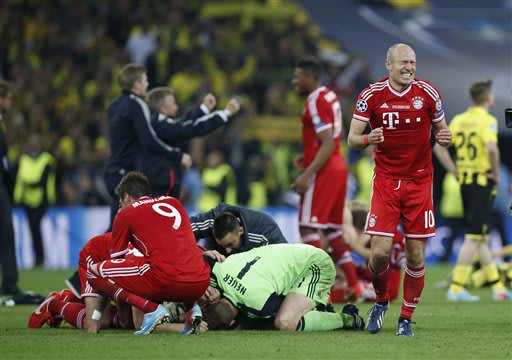 Bayern's Arjen Robben of the Netherlands, right, and teammates react after the final whistle and winning 2-1 the Champions League Final soccer match against Borussia Dortmund at Wembley Stadium in Lon