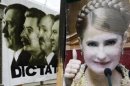 A portrait of former Ukrainian PM Yulia Tymoshenko is seen in front of the portraits of Hitler, Stalin, Lukashenko and Yanukovych at central Kiev