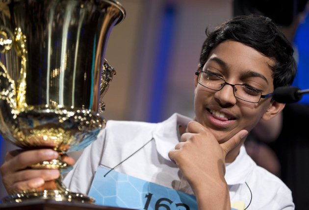 Arvind Mahankali, 13, of Bayside Hills, N.Y., holds the championship trophy after he won the National Spelling Bee by spelling the word "knaidel" correctly on Thursday, May 30, 2013, in Oxon Hill, Md. (AP Photo/Evan Vucci)