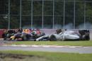 Red Bull driver Sebastian Vettel (C) passes by as Williams driver Felipe Massa (R) and Force India driver Sergio Perez crash at turn 1 during the Canadian Formula One Grand Prix on June 8, 2014