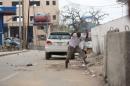 A man raises his hands as he runs from the scene of a suicide bomb attack outside Nasahablood hotel in Somalia's capital Mogadishu