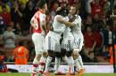 Swansea City's Bafetimbi Gomis, second left, celebrates after scoring the only goal of the game during their English Premier League soccer match between Arsenal and Swansea City at the Emirates stadium in London, Monday,May 11, 2015. Swansea won 1-0, with Gomis's header confirmed by goal line technology that it was a goal and had fully crossed the line. (AP Photo/Alastair Grant)