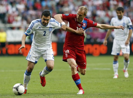 Greece's Yiannis Maniatis, left, and Czech Republic's Daniel Kolar fight for the ball during the Euro 2012 soccer championship Group A match between Greece and Czech Republic in Wroclaw, Poland, Tuesday, June 12, 2012. (AP Photo/Antonio Calanni)