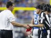 Field judge Greg Gautreaux (80) hands the red challenge flag back to Detroit Lions head coach Jim Schwartz in the first half of an NFL football game against the Houston Texans at Ford Field in Detroit, Thursday, Nov. 22, 2012. Houston won 34-31 in overtime. (AP Photo/Rick Osentoski)