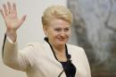 Lithuania's President Dalia Grybauskaite and presidential candidate celebrates winning a second term in office with his supporters in Vilnius, Lithuania,Sunday, May 26, 2014. (AP Photo/Mindaugas Kulbis)